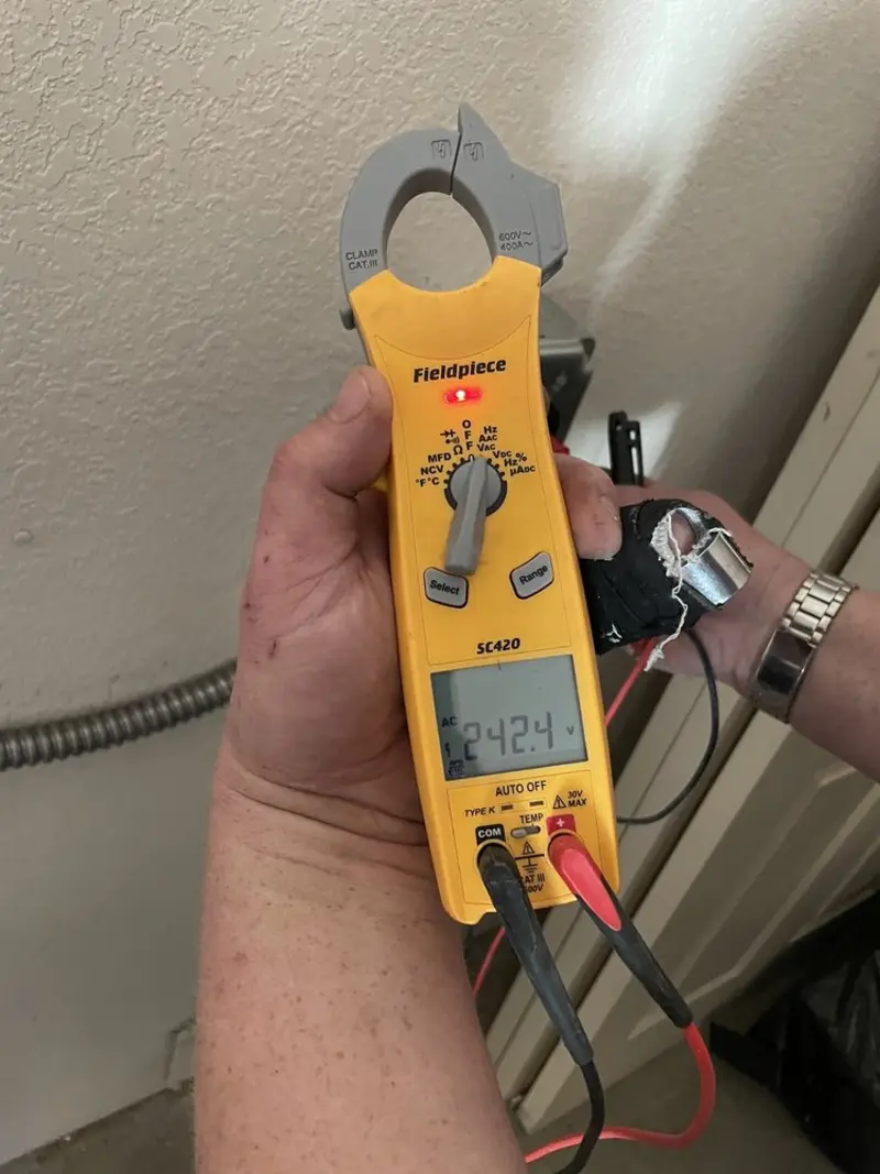 Voltage testing with clamp meter during Generator Installation in Sierra Madre